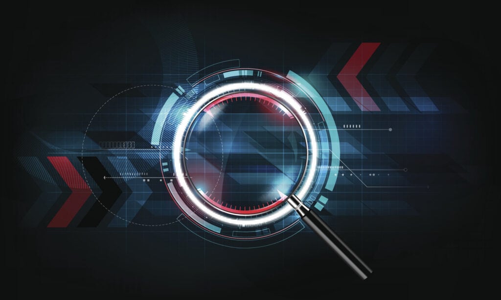 A digital magnifying glass with a glowing white and blue frame over a dark, grid-patterned technological background with red and blue geometric shapes.