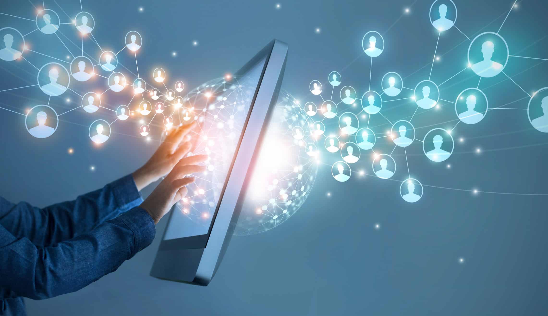 Hands interacting with a glowing digital screen, surrounded by a network of interconnected user profile icons.