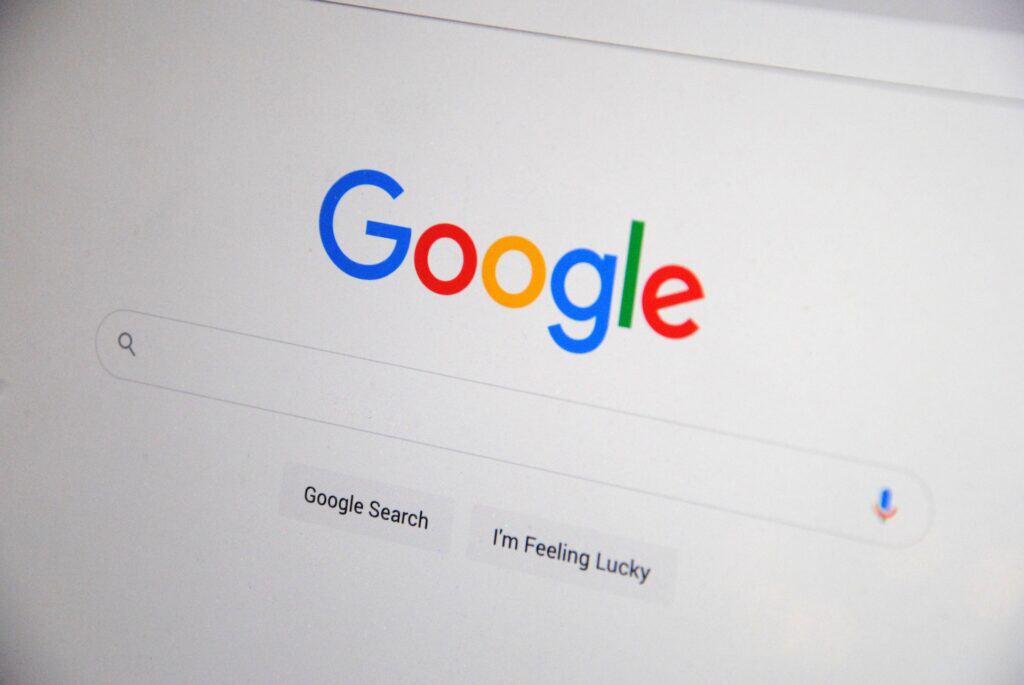 Google search engine homepage with colorful logo, search bar, and 'Google Search' and 'I'm Feeling Lucky' buttons.