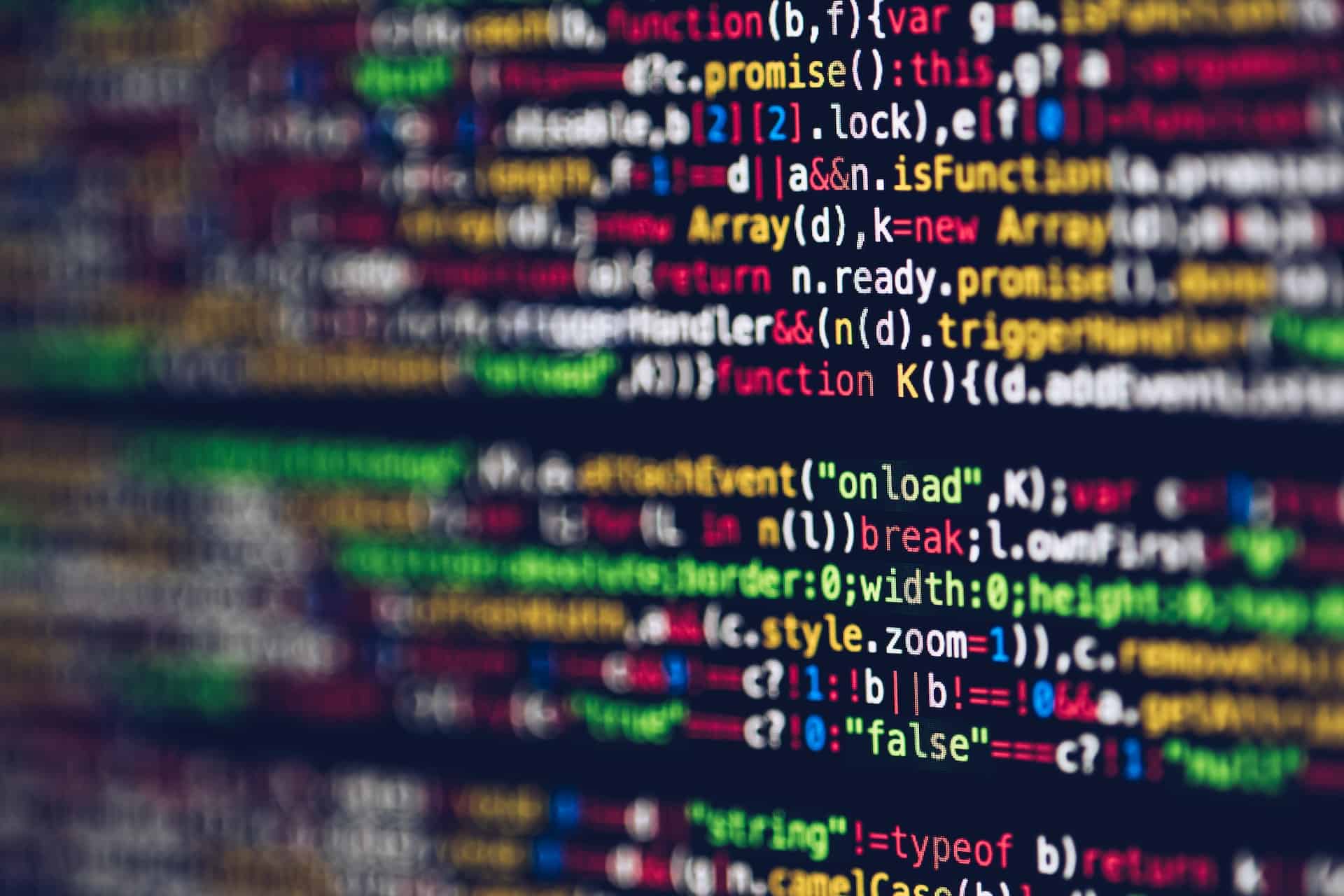 Close-up of colorful computer code on a dark screen, with some lines in focus and others blurred.