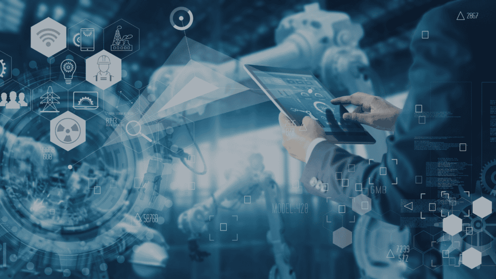 Hands holding a tablet with a digital interface, overlaid with tech icons and data, against a blurred industrial background with robotic arms.