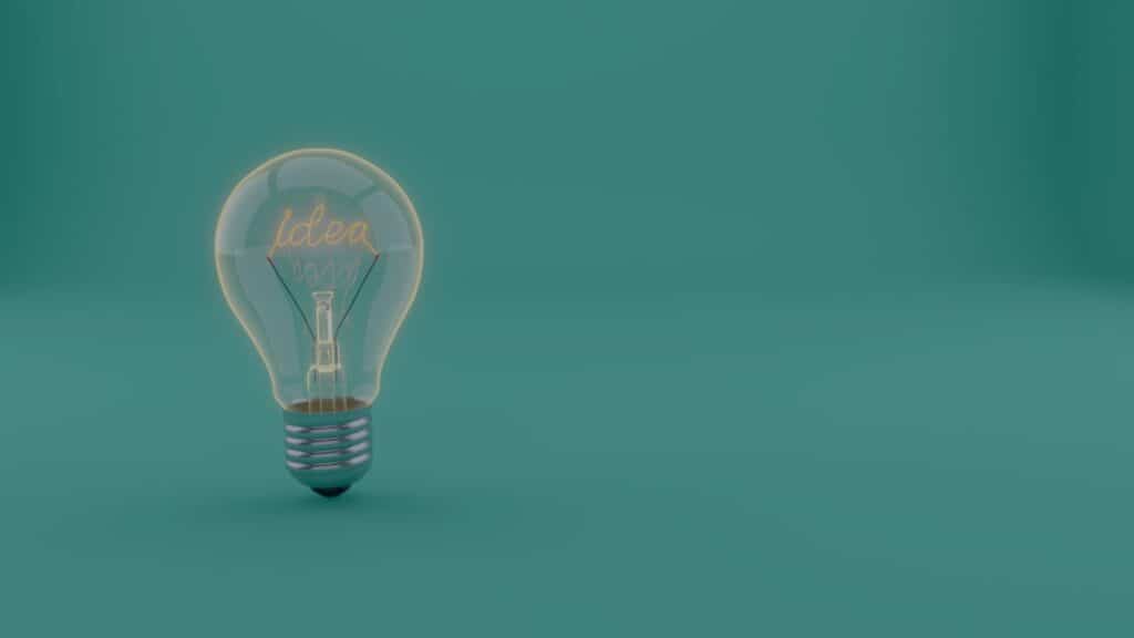 A 3D rendered light bulb with the word "idea" glowing inside, set against a teal background.
