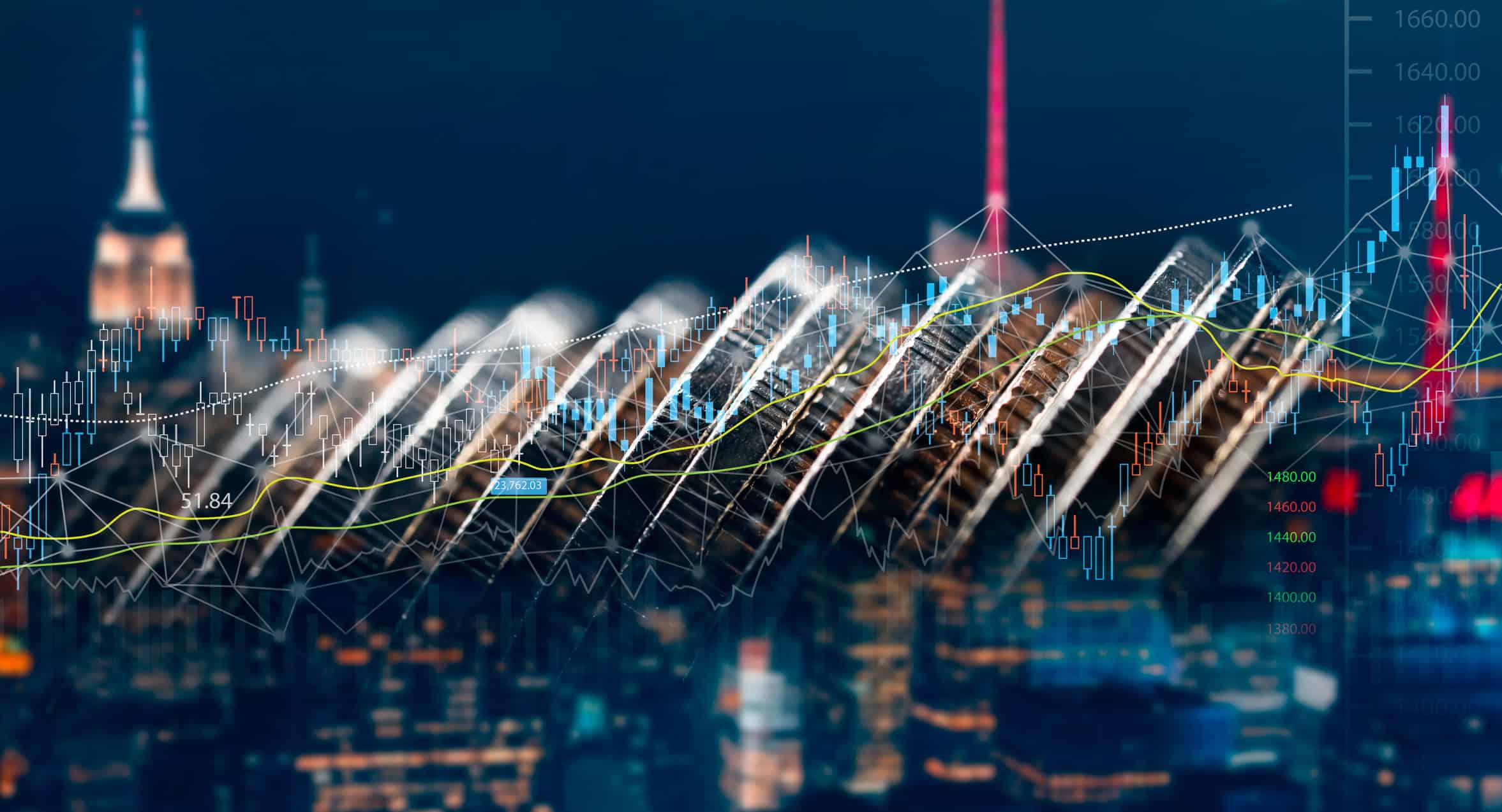 Financial charts and data overlaid on a diagonal row of coins with a blurred night city skyline in the background.