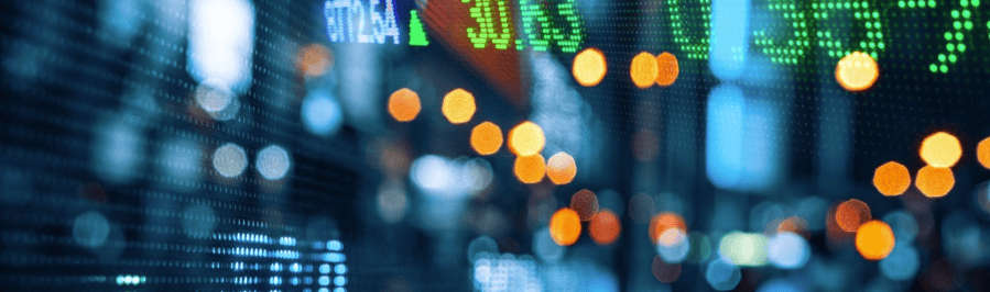 Blurred digital display with green financial numbers and an upward arrow, surrounded by orange and blue bokeh lights.