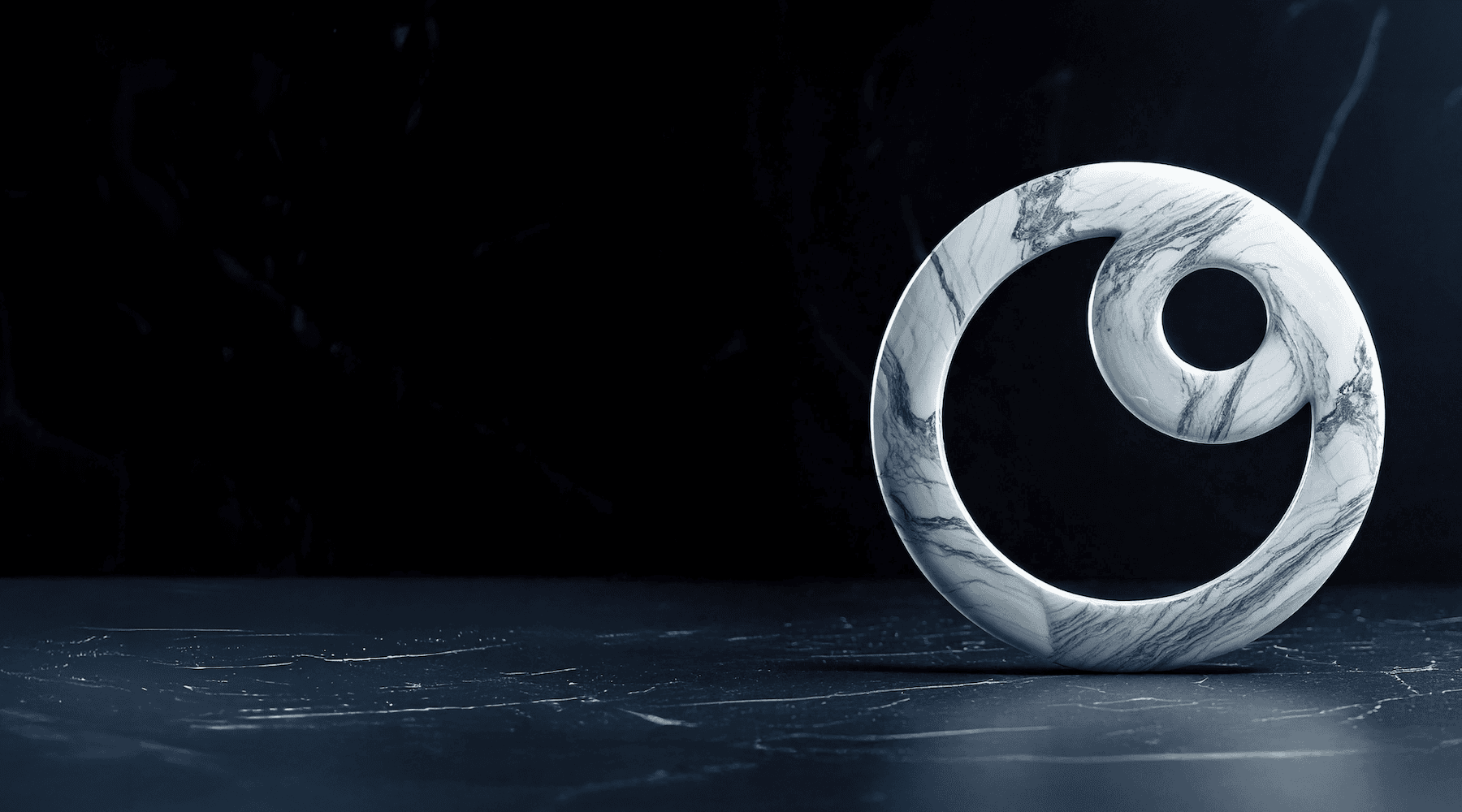 A white marble spiral sculpture with gray veining stands on a dark marble surface against a dark marble background.