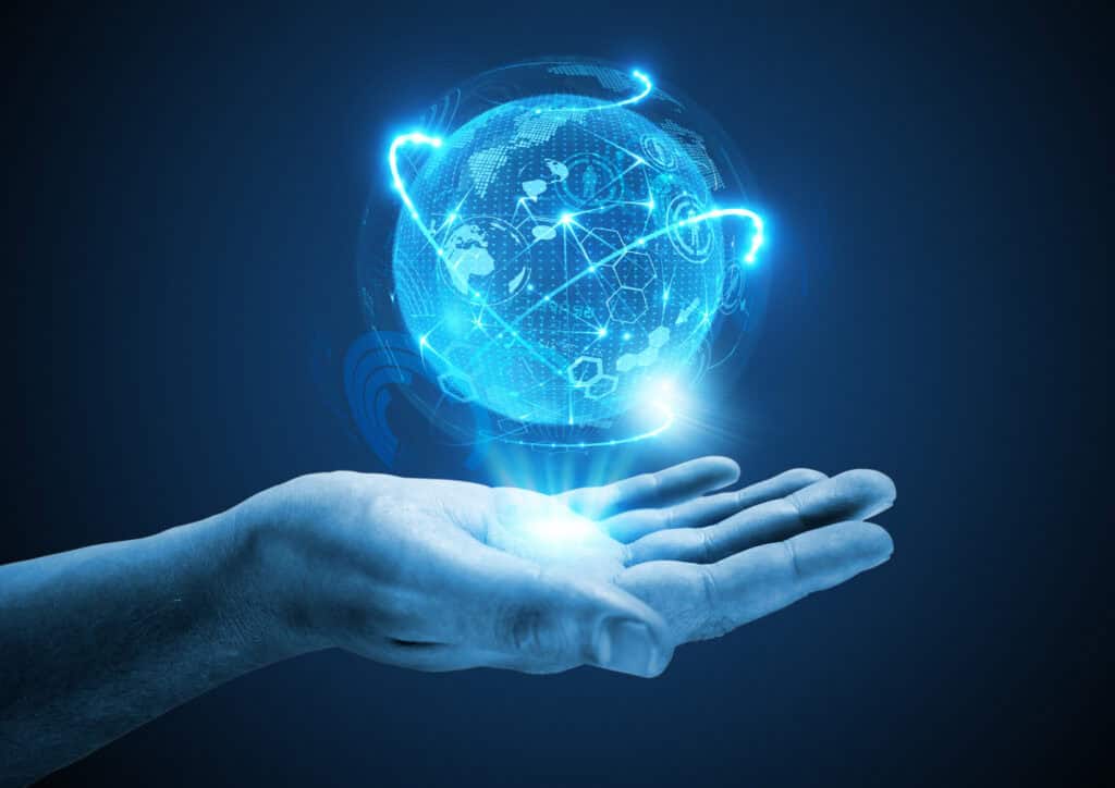 A human hand holding a glowing blue digital globe with network lines and icons, symbolizing global connectivity.