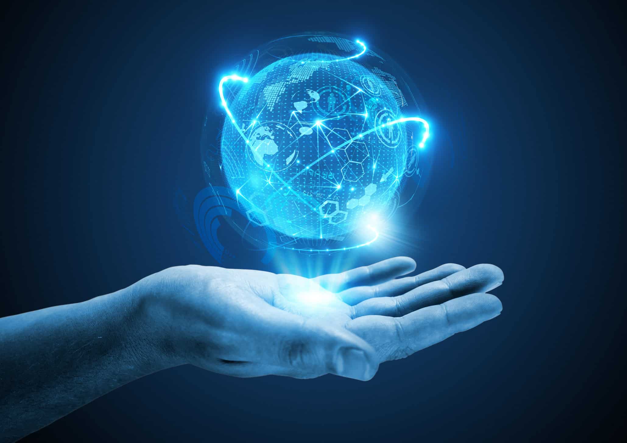 A human hand holding a glowing blue digital globe with network lines and icons, symbolizing global connectivity.