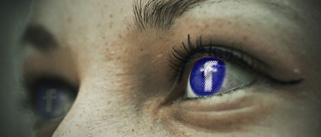 Close-up of a person's eyes, with the Facebook 'f' logo replacing the irises in both eyes.