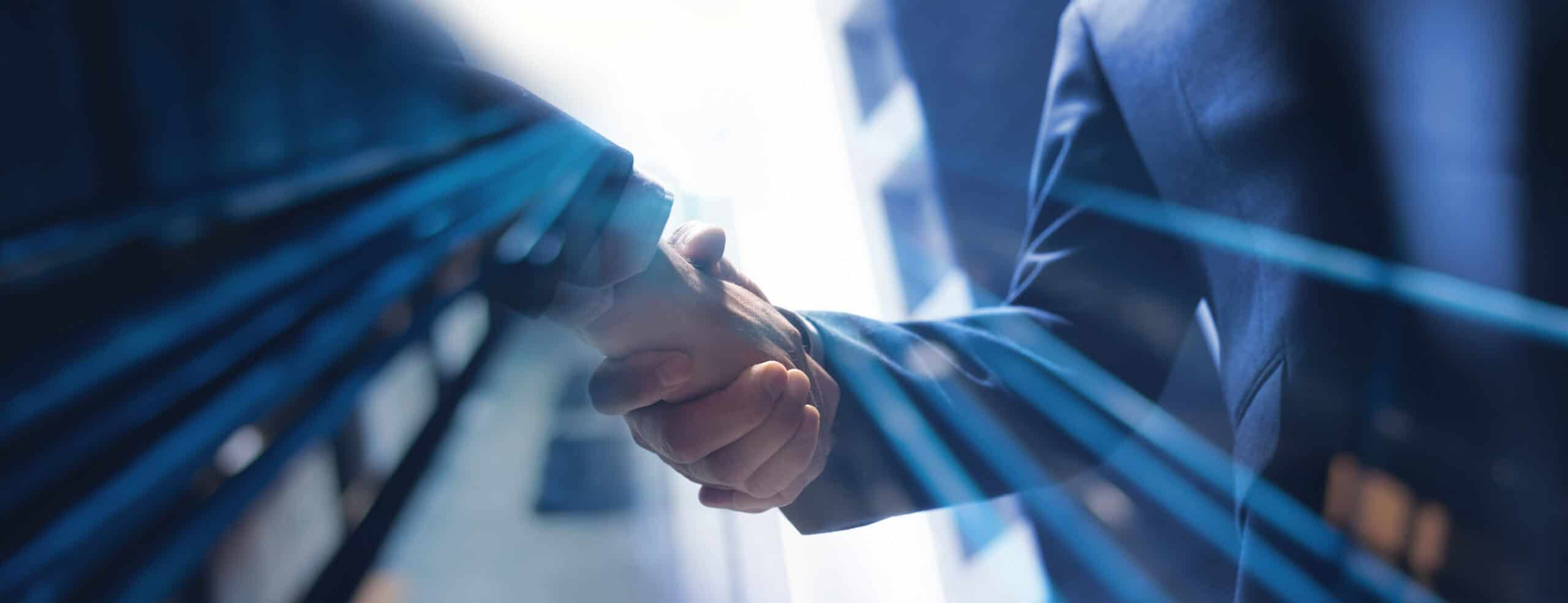 Two people in business suits shaking hands, with blue light streaks overlaying the image.