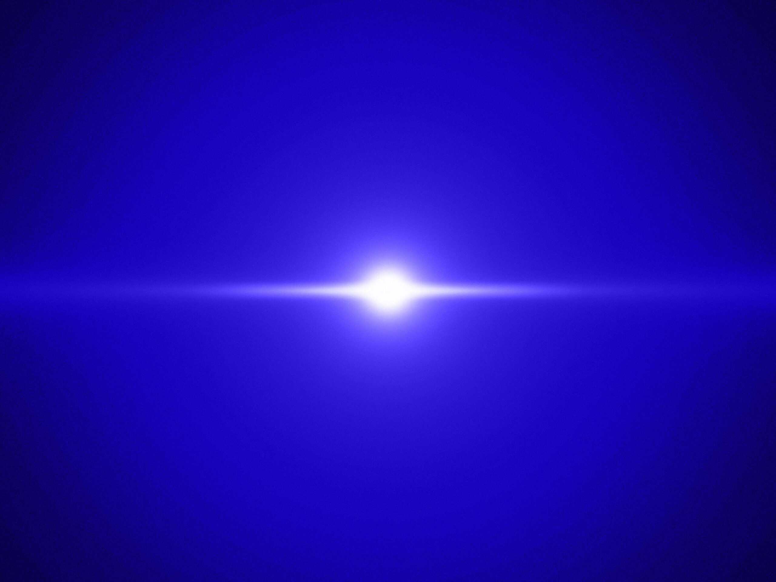 A bright white light source with a horizontal lens flare on a dark blue, textured background.