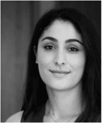 Black and white headshot of a woman with dark hair, looking slightly to the side with a subtle smile.
