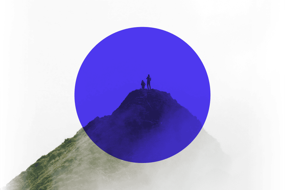 Two hikers silhouetted on a grassy mountain peak, partially covered by a large, semi-transparent blue circle.