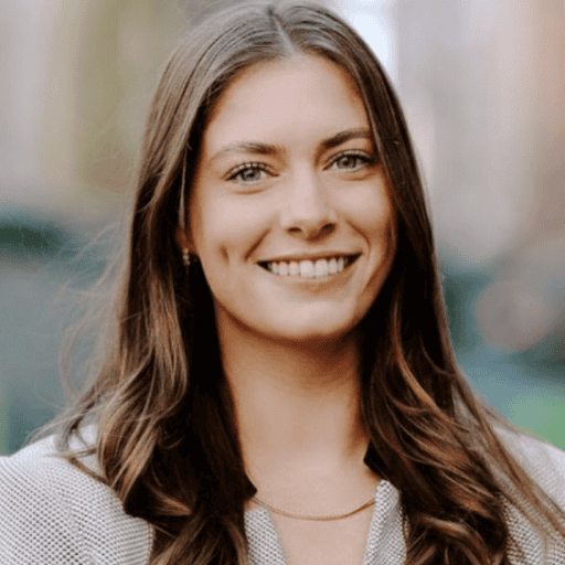 Headshot of a smiling young woman with long brown hair and light eyes.