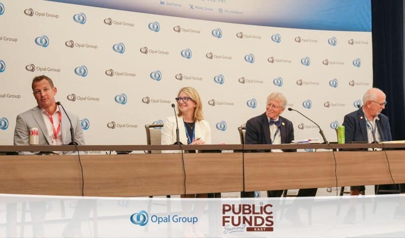 Four panelists, two men and a woman, seated at a table with microphones in front of a backdrop with Opal Group logos at the Public Funds Summit East.