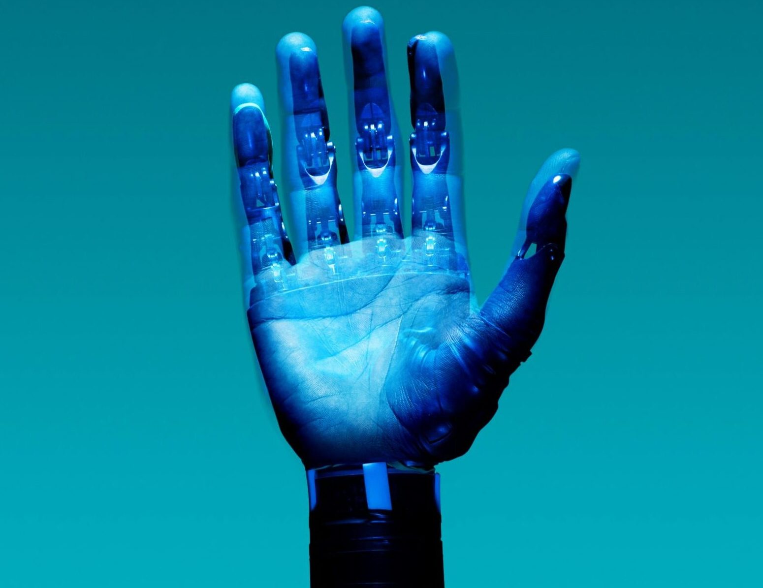 A translucent blue robotic hand overlaid on a human hand, set against a solid turquoise background.
