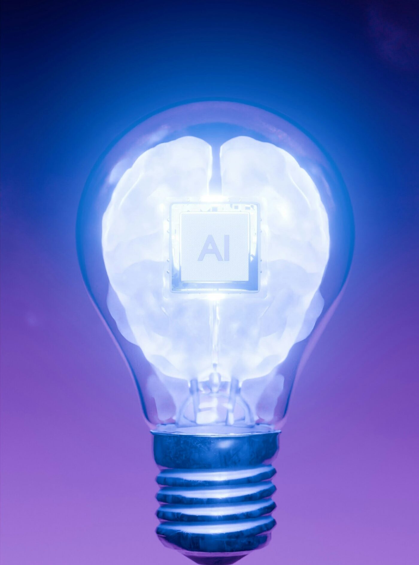 A glowing lightbulb containing a translucent brain with an 'AI' chip at its center, set against a blue and purple gradient background.